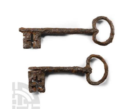 Early 18th century A.D.. Comprising one with kidney-shaped bow and square bit with cruciform void, the other similar with slo