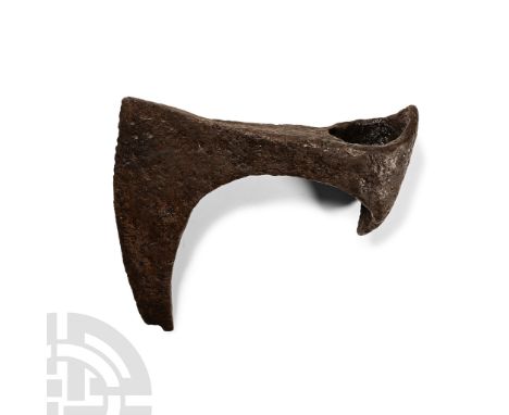 Circa 10th-12th century A.D.. With broad curved blade and short spur beneath the chin, narrow neck, deep socket with extended