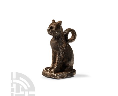 Late Period, 664-332 B.C.. Modelled seated on a tongue-shaped base, with fur detailing and suspension loop to the back. Cf. A