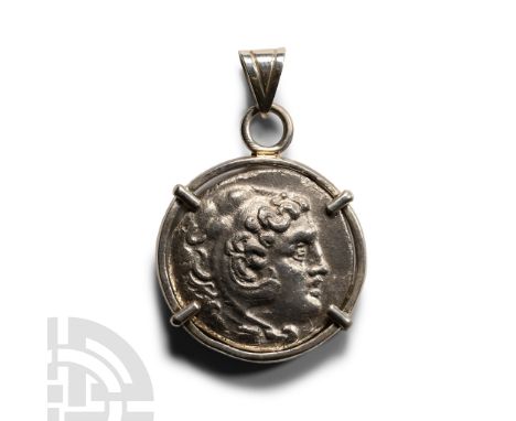 3rd century B.C. and later. Silver tetradrachm with profile bust to obverse, seated figure with bird to reverse; clasp-mounte