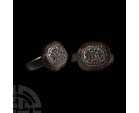 Circa 16th century A.D.. Comprising a broad hoop, octagonal bezel with chamfered edges, punched-point border, central motif o