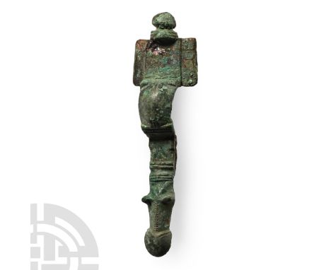 Circa 6th century A.D.. A bronze cruciform brooch formed of a raised rectangular headplate with rectangular lateral wings sur