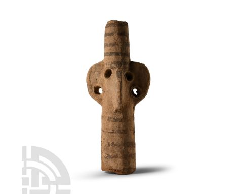Middle Bronze Age, circa 2000-1650 B.C.. Columnar in form with lateral lugs pierced at the lower edge and impressed eyes; pai