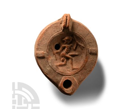 2nd-3rd century A.D.. With lug handle and short nozzle, low-relief scene of a nude dancer running brandishing batons. Cf. Bém