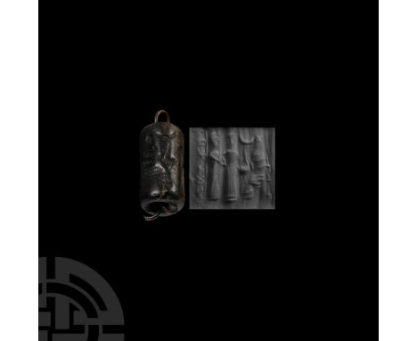 2nd-1st millennium B.C.. With large central hole, incised frieze of a seated figure receiving an offering from a figure in fl
