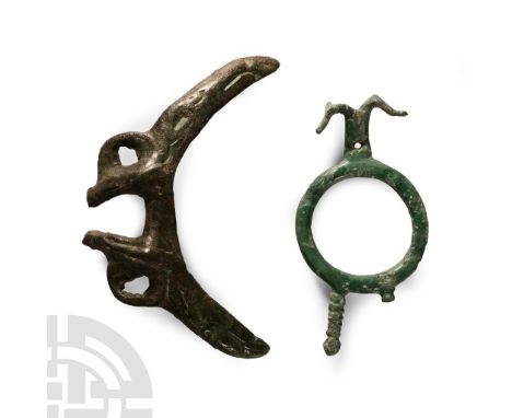 Circa 8th-7th century B.C.. Comprising: a ring brooch with addorsed horse-heads; crescent mount fragment with eagles' claws. 