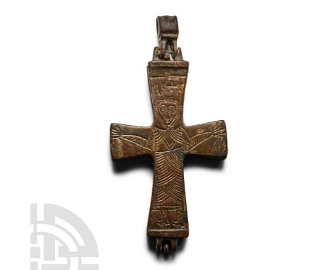 10th-12th century A.D.. Articulated enkolpion with loop; low-relief robed figure to reverse in orans pose with legend above '