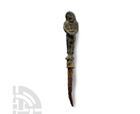 1st-2nd century A.D.. With an iron pin, the finial formed as a standing comedy actor with long curly hair, hands clasped toge