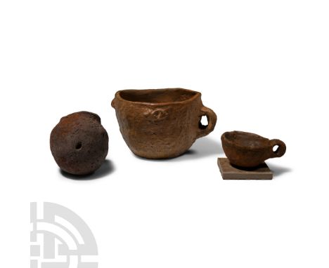 Late Bronze Age, 1200-750 B.C.. Comprising: broad cup with single loop handle; bulbous pot with raised rim; smaller cup on a 