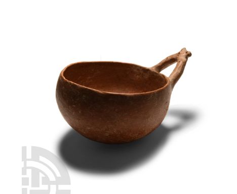 Middle Bronze Age I-II, circa 2000-1750 B.C.. Hemispherical body with wishbone anthropomorphic handle, burnished surface.  20