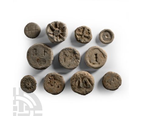 13th-16th century A.D.. Group of drum-shaped and discoid weights, some with impressed symbols or legend to one face. Bailey, 