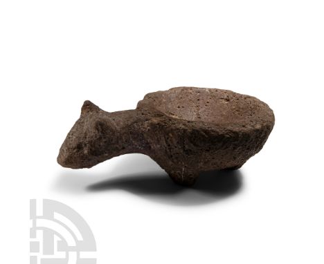 Neolithic Period, circa 4th-3rd millennium B.C.. Squat dish with three stub feet, handle formed as a canine head and neck.  4