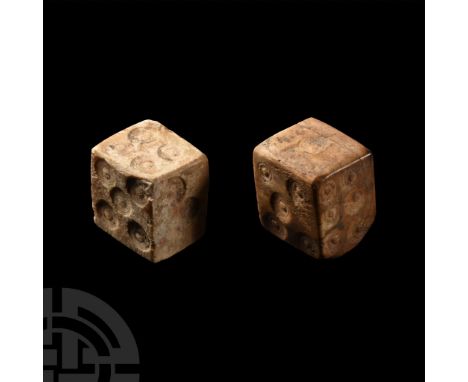 2nd-4th century A.D.. Two roughly cuboid dice with ring and dot markings disposed 1:5, 2:4, 3:6; 1:2, 3:6, 4:5.  3.28 grams t