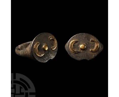 5th-4th century B.C.. With ellipsoid plaque, applied silver-gilt central boss flanked by two applied crescents.  3.89 grams, 