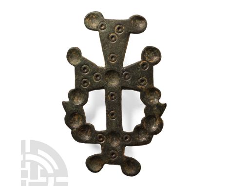 Circa 6th-8th century A.D.. Formed as an expanding-arm cross pommy with lower arm developing two lateral loops with shallow r