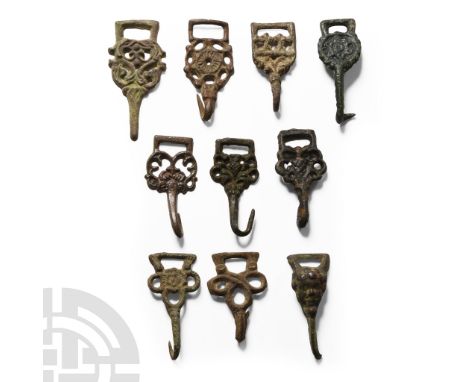 16th century A.D.. Group of hooked tags of various forms including rosette and openwork types; many of these objects are publ