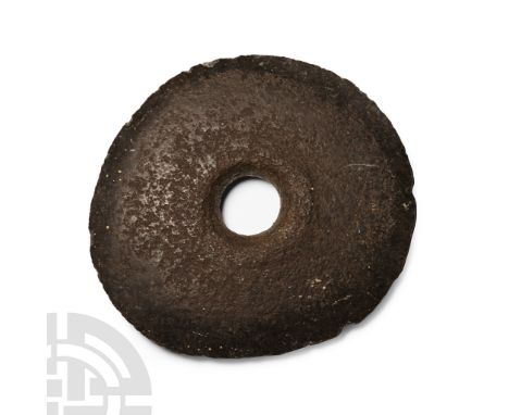 Neolithic Period, circa 2500-1500 B.C.. Circular in plan with worked cutting edge all round, socket with one chamfered face. 