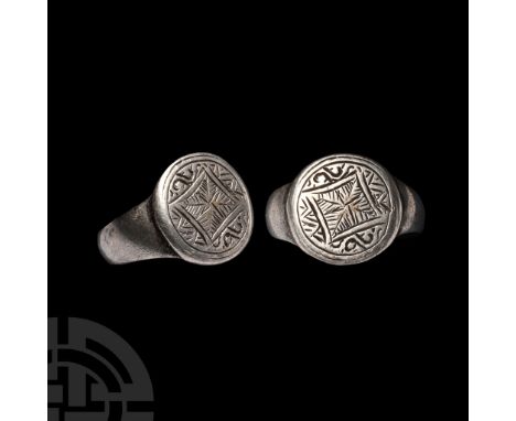 Circa 14th-16th century A.D.. With broad hoop and stud to underside, disc bezel with low-relief geometric lozenge motif on a 