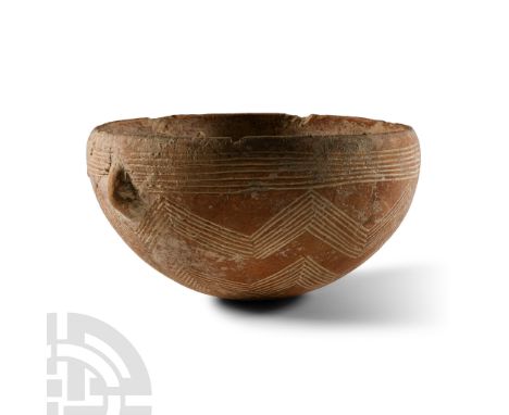 Bronze Age, circa 2000-1600 B.C.. Hemispherical in profile with slightly inverted rim, band of circumferential incised lines 