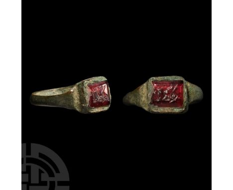 2nd-4th century A.D.. With a slender D-section hoop, square raised bezel set with red carnelian intaglio, engraved with a rec