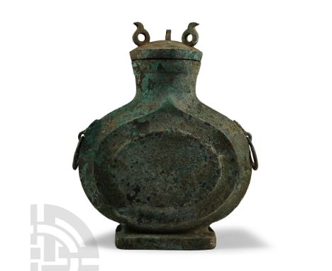20th century A.D.. With slim, circular body resting on a rectangular foot; two ring handles with lion-head appliqués; domed l