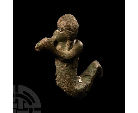 1st-2nd century A.D.. Long haired, human face with detailed scaly fish body, glass insert preserved in the eye, in the act of