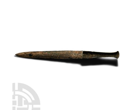 13th-12th century B.C.. With lentoid-section blade, tongue-shaped in plan, integral tapering hilt with flared finial, lateral