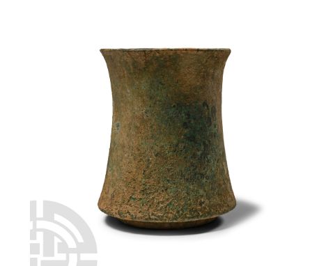 2nd-1st millennium B.C.. Tubular with slightly flared rim and expanding towards the base, carinated with a raised basal ring.