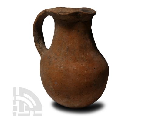 Middle-Late Bronze Age, 2000-1200 B.C.. Globular in profile with pinched trefoil mouth and strap handle to the rear; inked ac