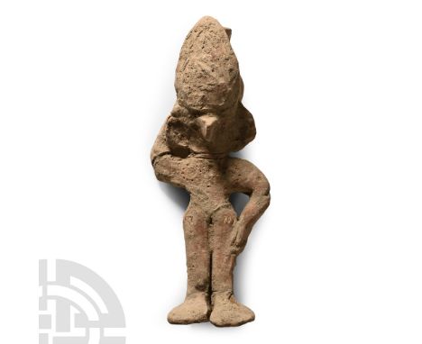 12th-14th century A.D. or later. Hand-modelled Chancay(?) figure of a standing female with left hand on her hip and right han
