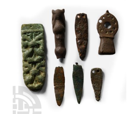 5th-11th century A.D.. Comprising: a plain Roman lanceolate strap end; a strap end with an animal head terminal and interlace