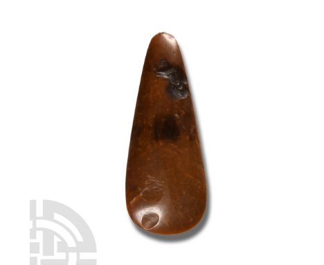Neolithic Period, circa 4th-3rd millennium B.C.. With broad curved cutting edge tapering body and narrow tip, polished surfac