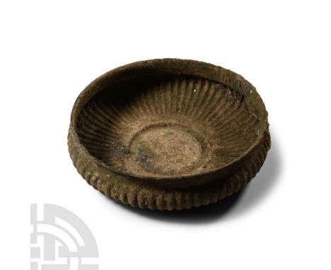 6th-4th century B.C.. A broad carinated bowl with radiating repoussé panels, central slightly domed roundel, carination below