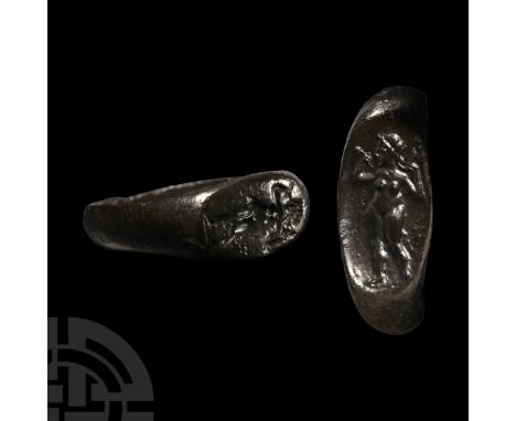 1st-2nd century A.D.. Ellipsoid bezel with intaglio image of Venus standing nude holding a mirror in one hand and dressing he