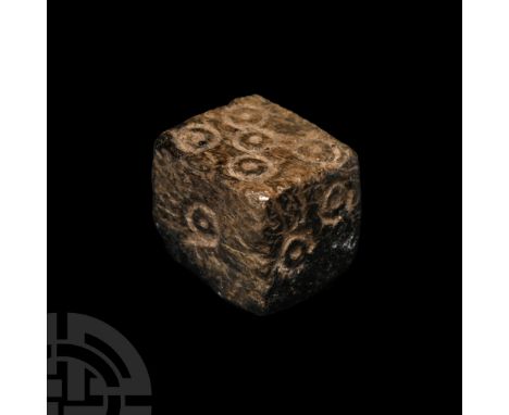 1st-4th century A.D.. Cuboid with incised ring-and-dot markings disposed 1:6, 2:4, 3:5; old collector's label '12' to one fac
