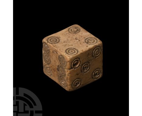 4th-6th century A.D.. Cuboid with incised ring-and-dot markings disposed 1:6, 2:5, 3:4; old collector's label '230' to one fa
