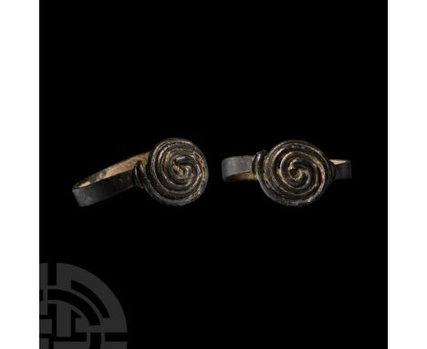 6th-10th century A.D.. Comprising a flat-section hoop tapering to narrow wire finials formed into a coil and the ends wound a