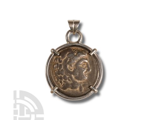 3rd century B.C. and later. Silver tetradrachm with profile bust to obverse, seated figure with bird to reverse; clasp-mounte