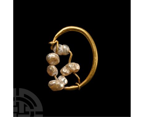 3rd century A.D.. Gold wire hoop with hook-and-eye closure, threaded with seed pearls. Cf. Ruseva-Slokoska, L., Roman Jewelle