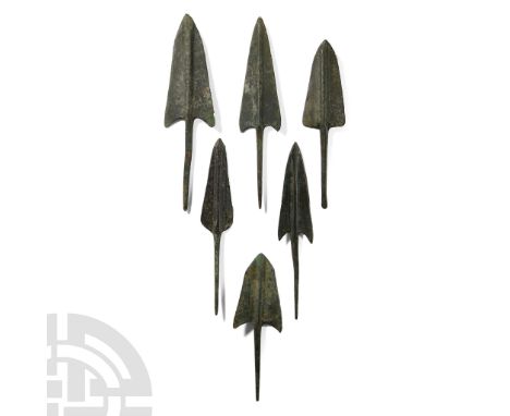 Circa 1000 B.C.. Each with an elongated, triangular shape with barbed shoulders, raised midrib and quadrangular spiked tang. 