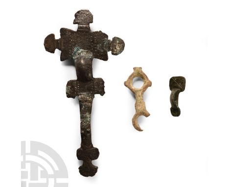 6th-10th century A.D.. Comprising: a small-long brooch with deep bow and square headplate with incised saltire; a strap-junct