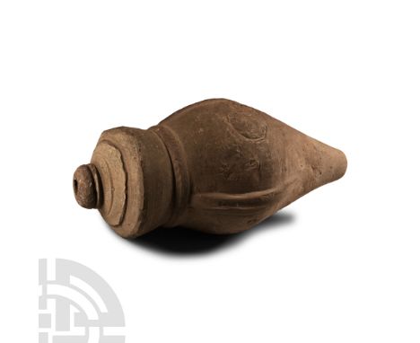 14th-15th century A.D.. A hollow vessel with cylindrical body, carinated shoulder, short neck and domed mouth, bands of impre
