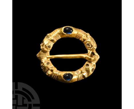 13th-14th century A.D.. Annular in plan with two segmented hoop, inset sapphire cabochons, separate pin. Bailey, G., Buttons 