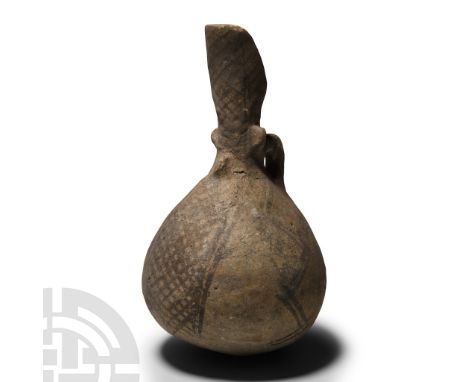 Middle Bronze Age, circa 2000-1650 B.C.. Bulbous in profile with scooped spout, loop handle, spurs to the junction, painted g