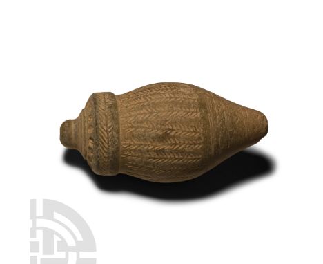 13th-15th century A.D.. A hollow vessel with cylindrical body, carinated shoulder, short neck and domed mouth, bands of impre