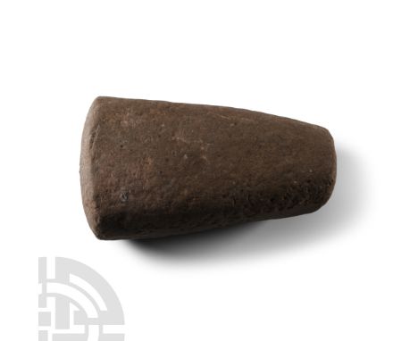 Neolithic Period, 4th-3rd millennium B.C.. Trapezoidal in section with slightly domed pounding face. Cf. MacGregor, A., (ed.)