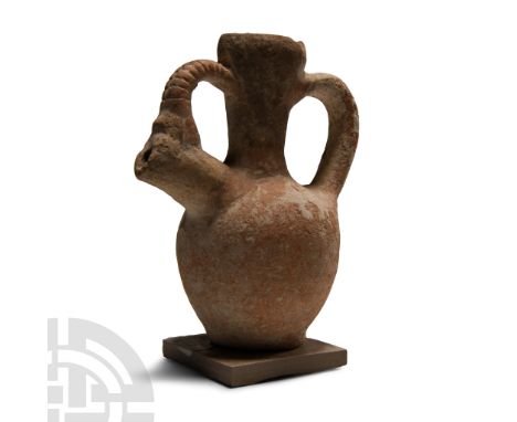 Middle Bronze Age, mid 2nd millennium B.C.. With ovate body and tapering neck and socketed mouth, strap handle to rear, spout