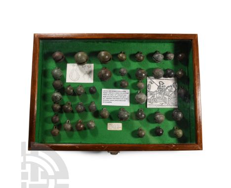 14th-19th century A.D.. Collection of crotal bells labelled and mounted in a felt-lined glazed wooden display case with expla