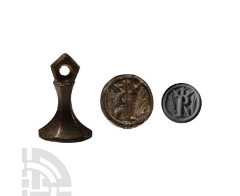 14th century A.D.. Chessman-type with pierced finial; die with capital 'R' beneath a crown surrounded by a wreath. Bailey, G.