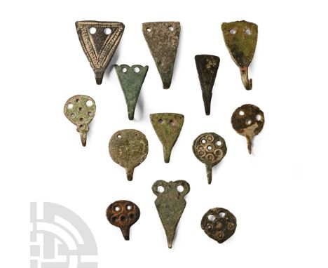 6th-8th century A.D.. Discoid and triangular hooked tags with attachment points; many of these are published in the Detector 